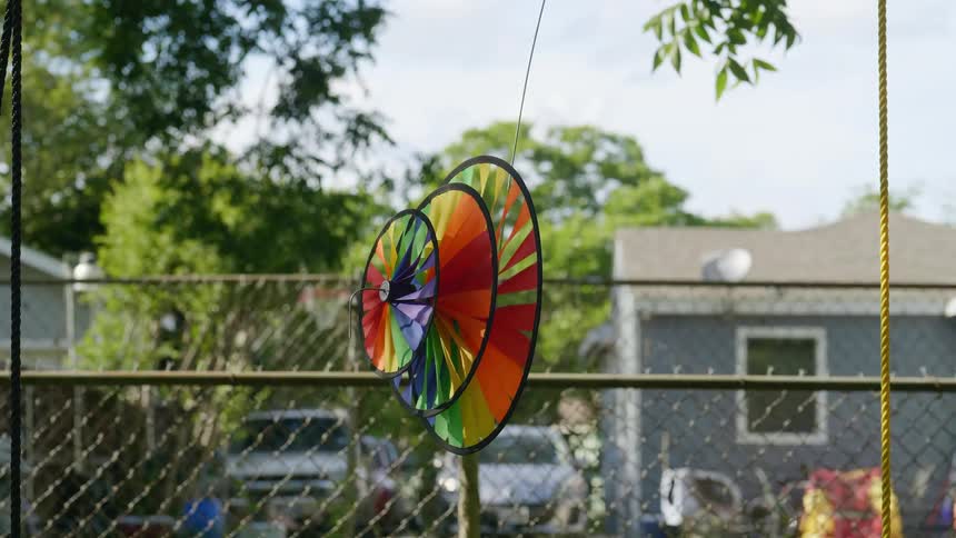 The rainbow fan is spinning in the yard