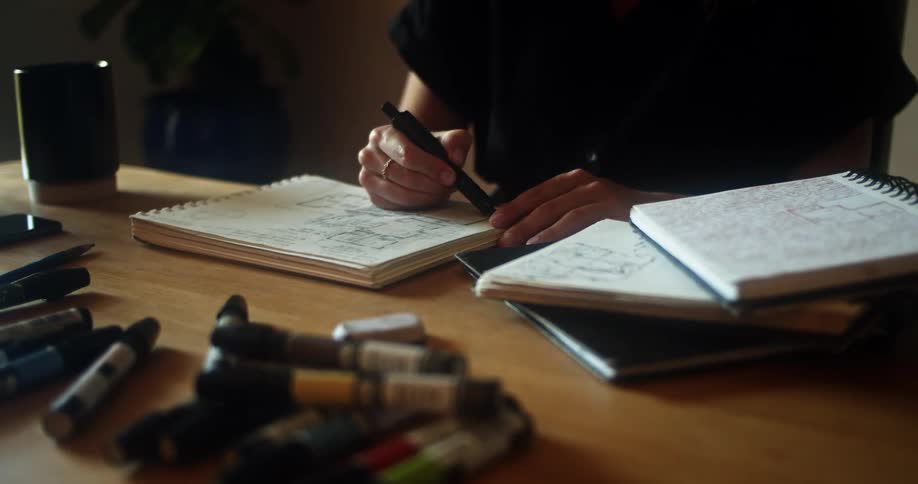 A person is writing in a book with a marker