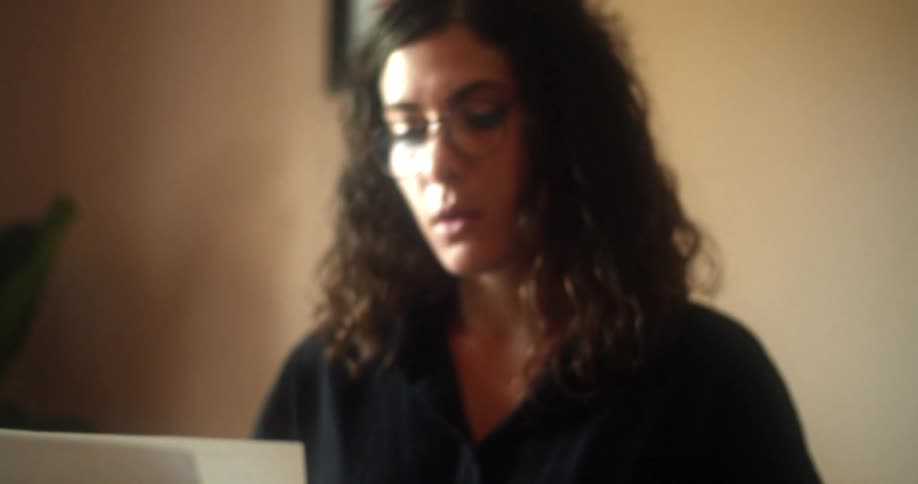 A woman is typing on an old typewriter