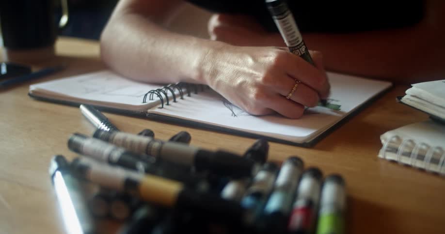 A woman in an office sketches a house plan