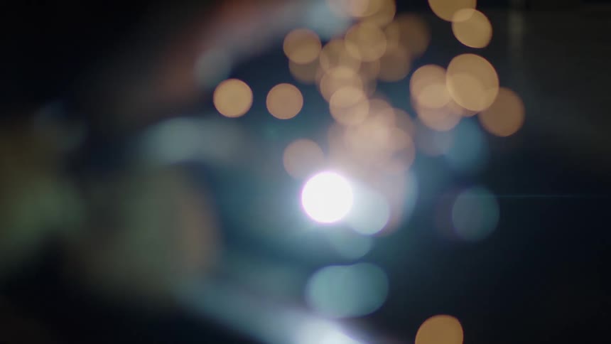 Sparks flying from end of torch with bokeh effect