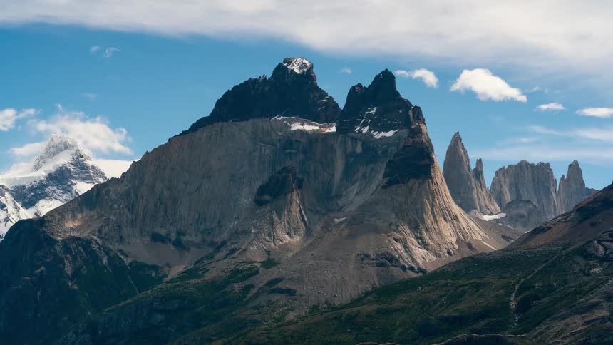 The mountain range has light snow on top