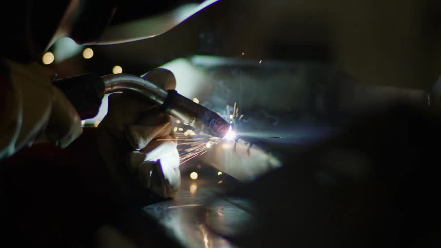 A person is welding metal with a torch