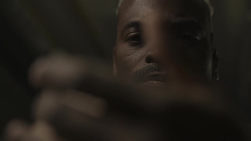A man tracing his hand across a piece of wood