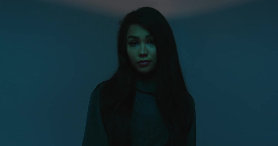 A woman standing in a room with lights lasers and shadow
