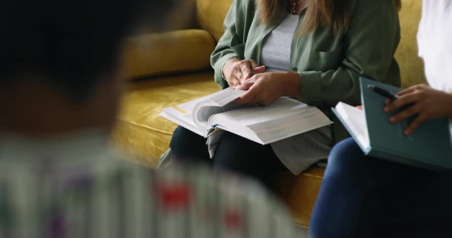 Group of woman sitting in a yellow couch read books in a study group