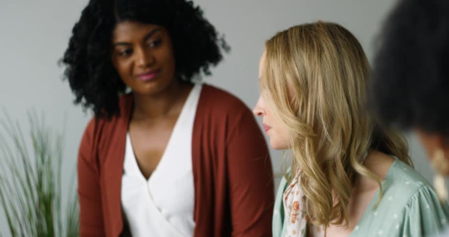 Women are talking and reading from a book