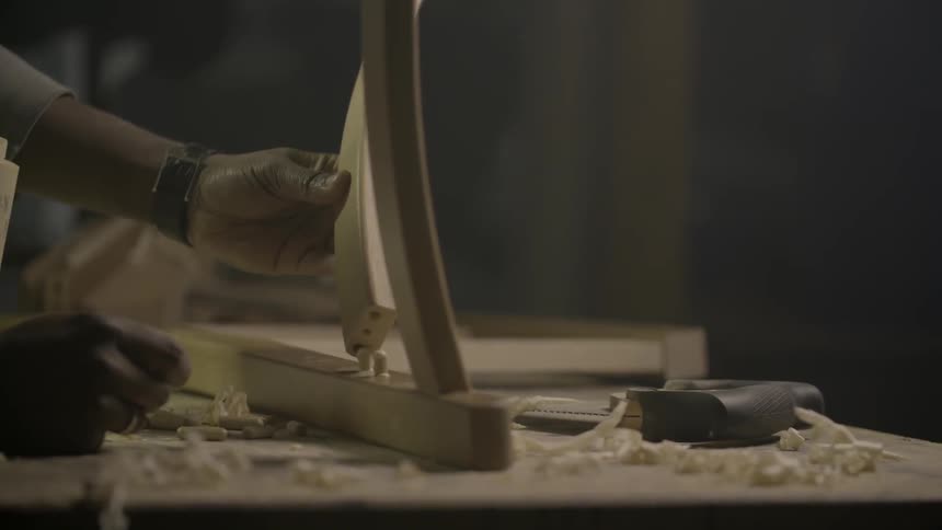 A person is applying glue to a chair