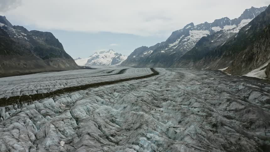 An aerial view of a mountain range is displayed