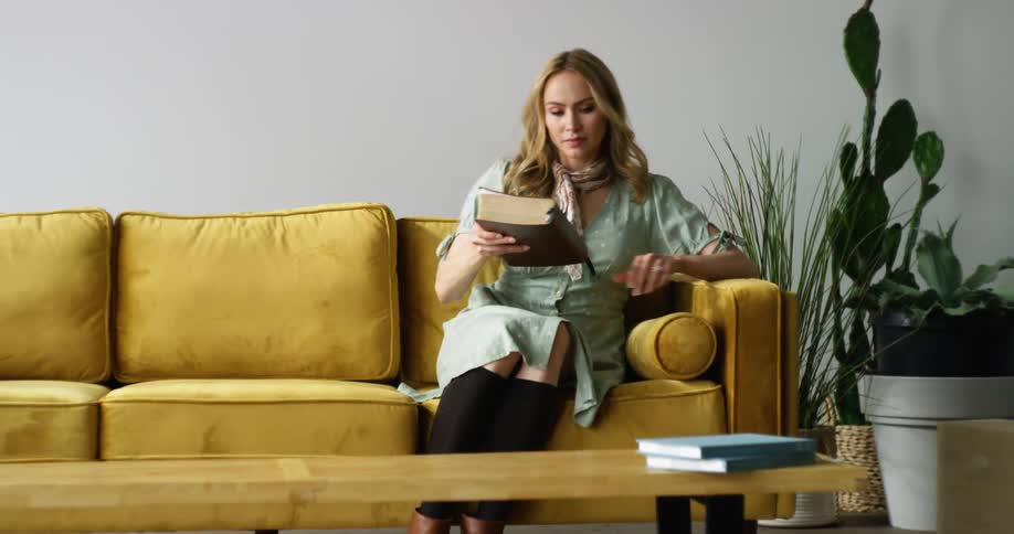 A woman puts the book down and walks away