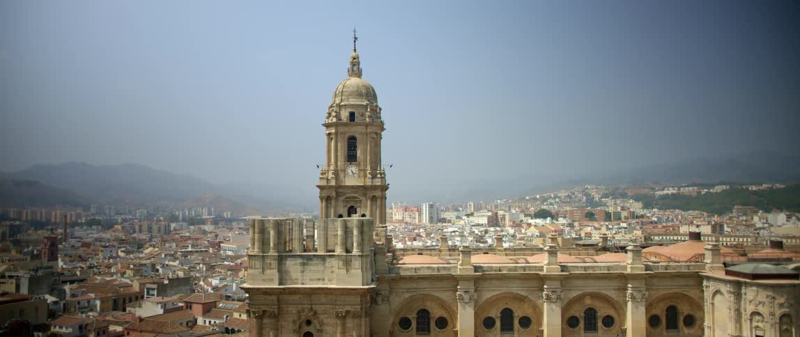 A large church in front of city skyline