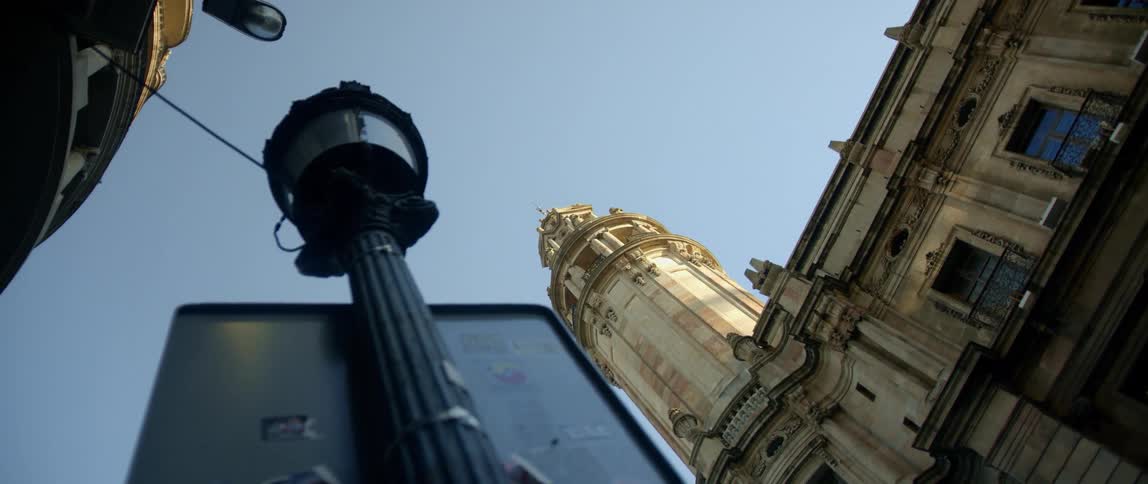A tall tower is near the building