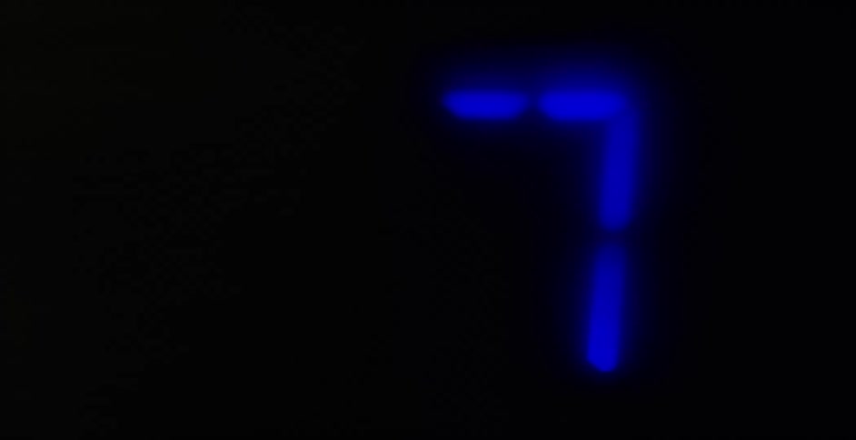A digital display of glowing blue numbers shows them counting down towards zero