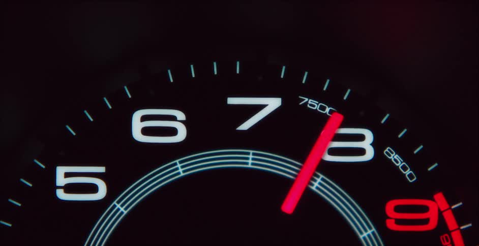 The needle on a tachometer swings to one side before slowly returning to the other side