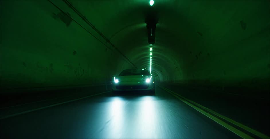 A car is driving through the tunnel