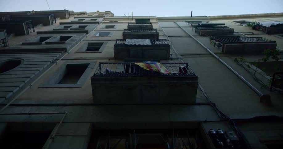 Flag hangs on a balcony on multistory building