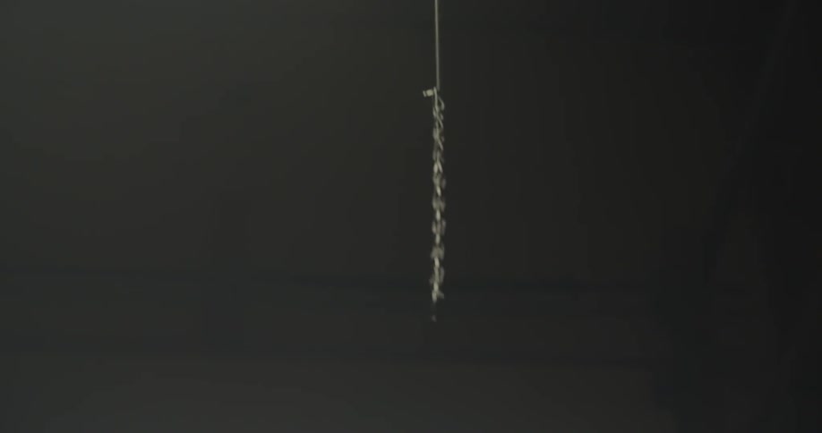 A chain attached to a rod is dangled in the air