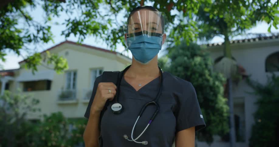 A young nurse outside a home