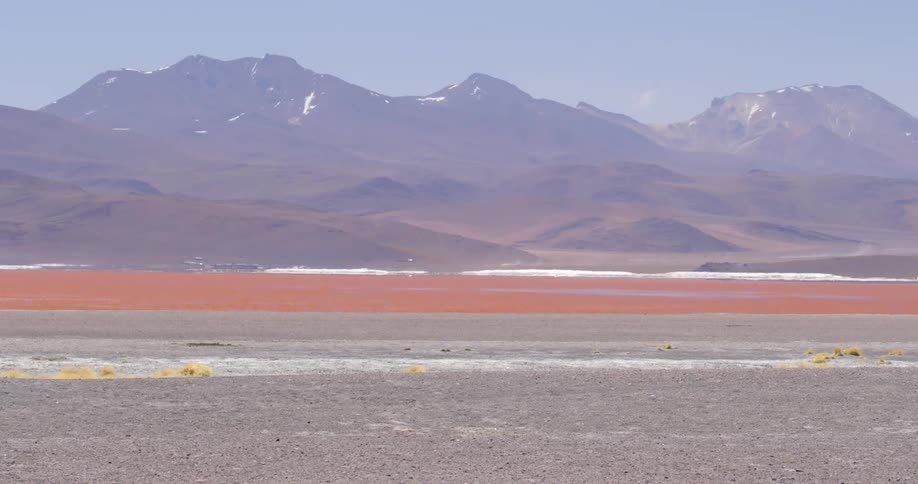 Red desert sands contrast with purple mountain ranges