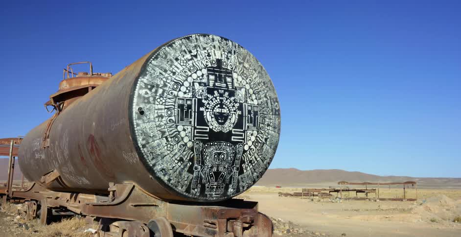 An old abandoned train sits in a desert area