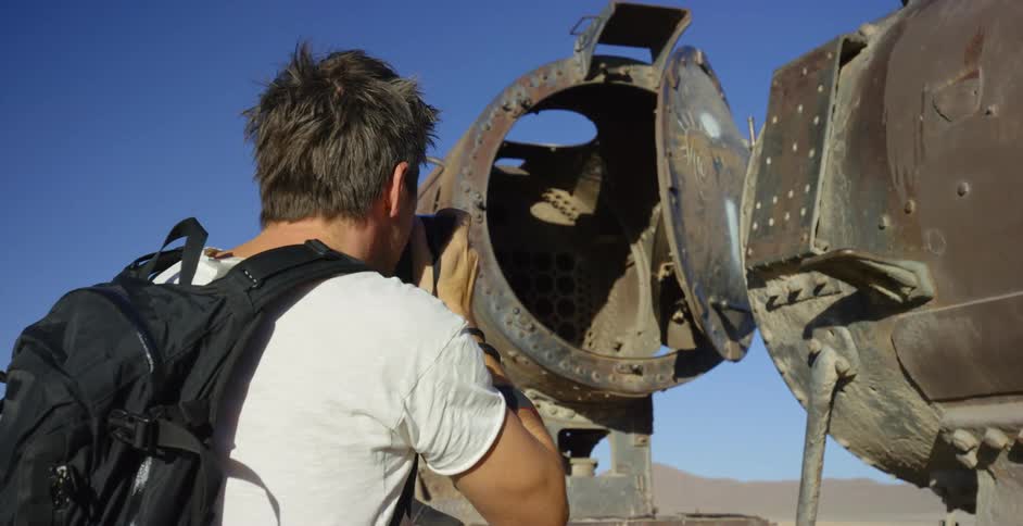 A man takes pictures of a vintage airplane