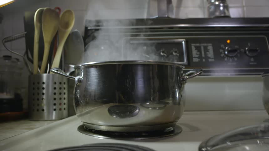 Steam rising from a pot on a stove top