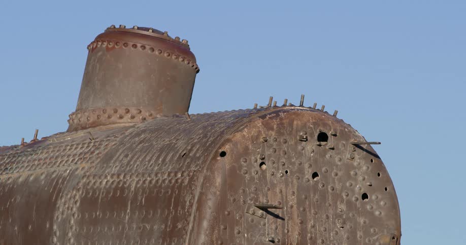 A rusted tank sitting outdoors