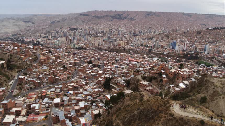 An aerial view of a city in a valley on an overcast day