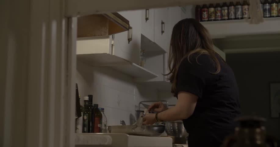 A woman cleaning up a kitchen