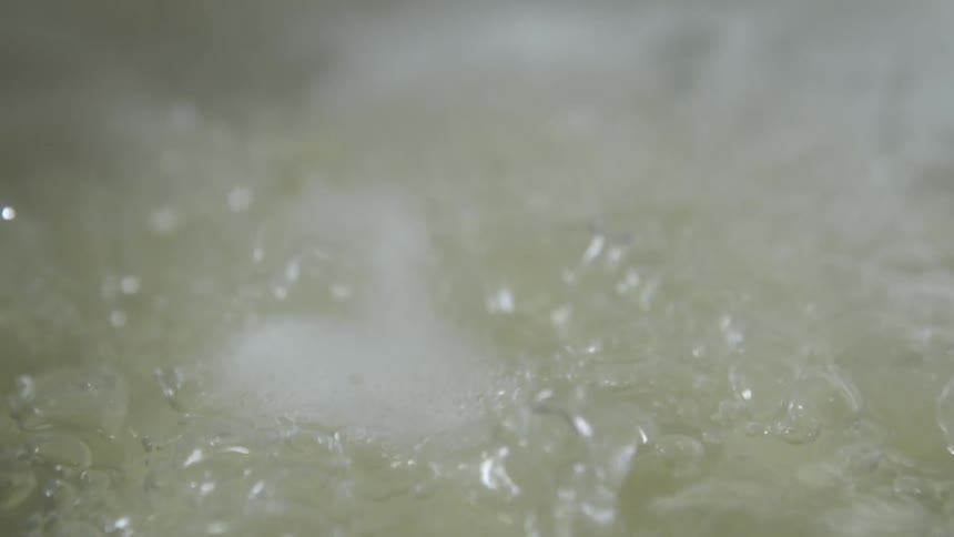 Close up of water boiling in a pot