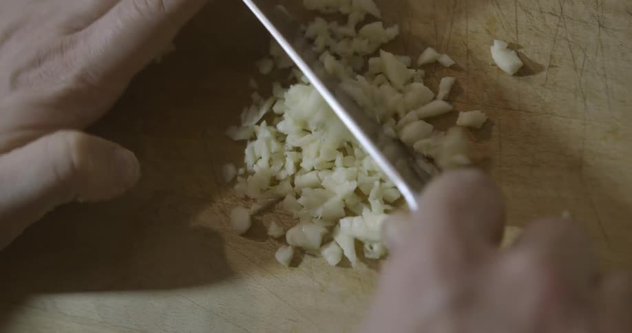 A person is cutting up some food on a board