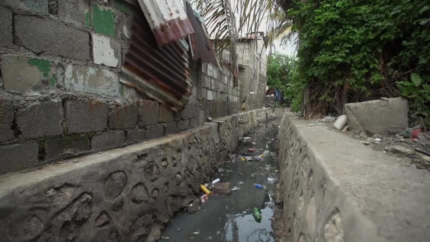 An alleyway filled with water and garbage