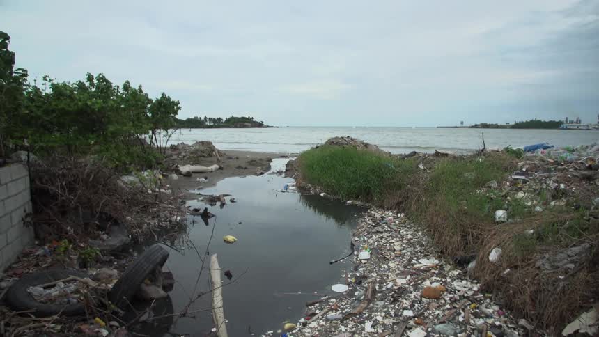 An area is flooded and covered in garbage