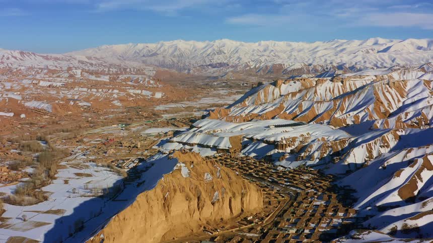 Aerial view of a mountain range with buildings at the base