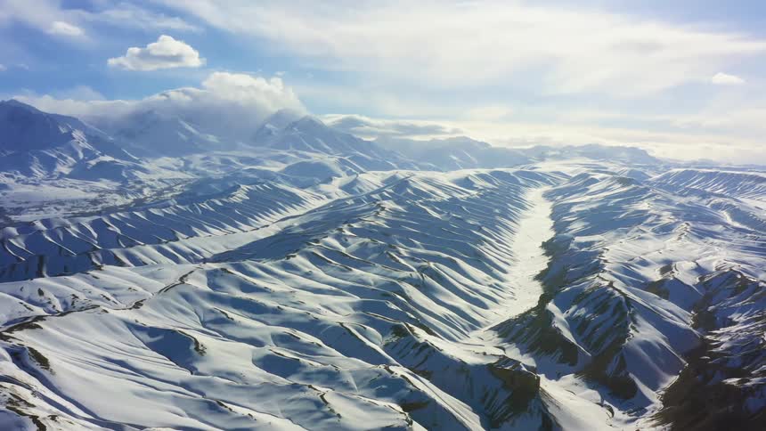 A snow covered mountain range on a sunny day