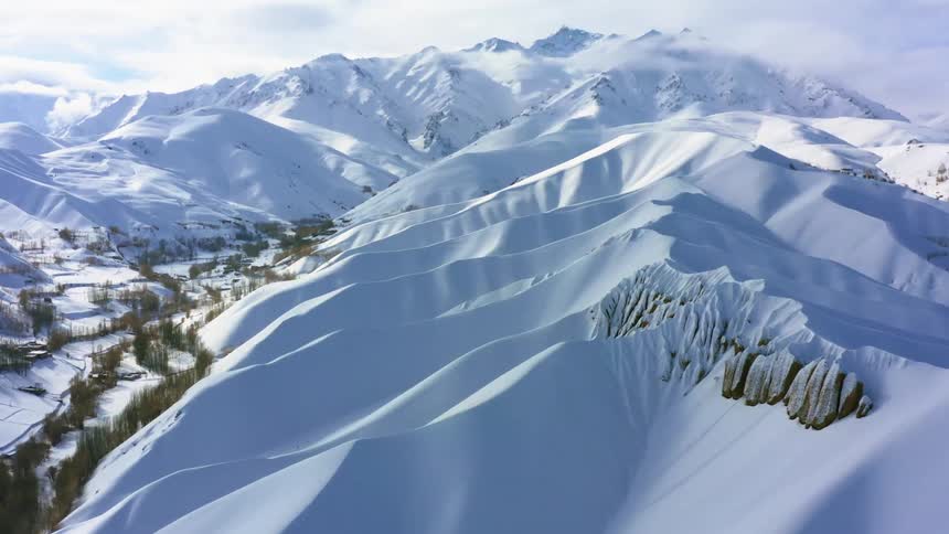 A snow covered mountain ridge on a sunny day