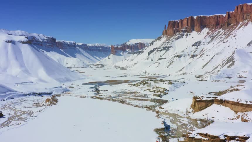 Snow and water fill a mountain valley in the winter