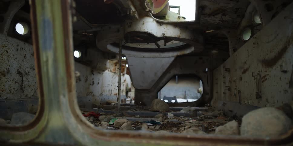 The ruins of a vehicle are covered in rust