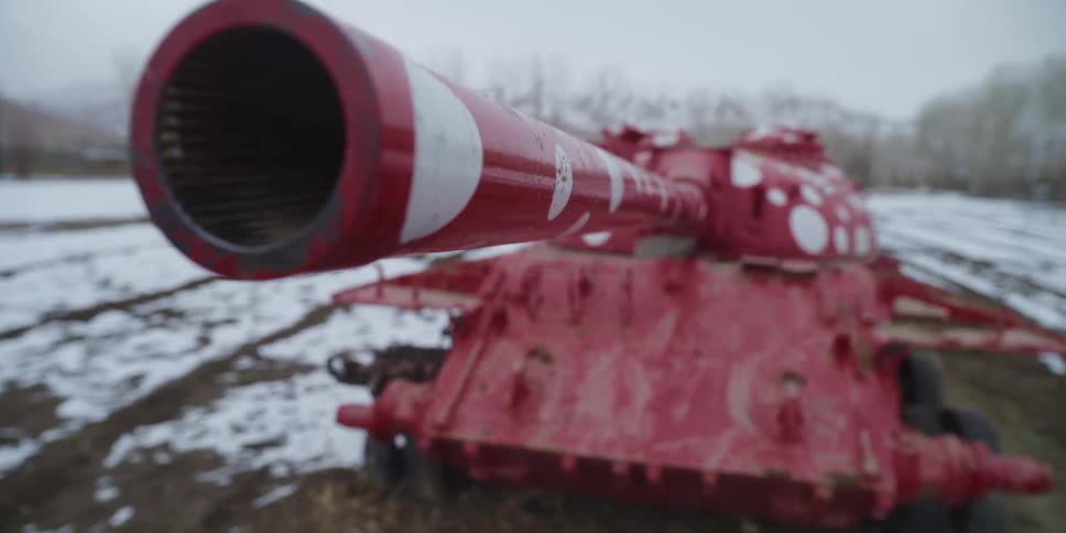A large red tank is on the field