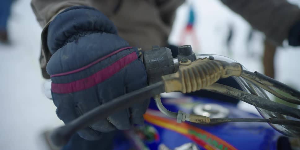 A person is sitting on their snowmobile