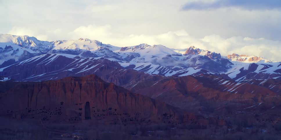 An aerial view of a mountain range is displayed