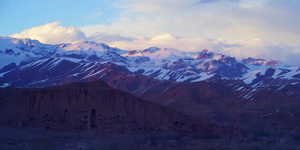 An aerial view of a snowy mountain is displayed