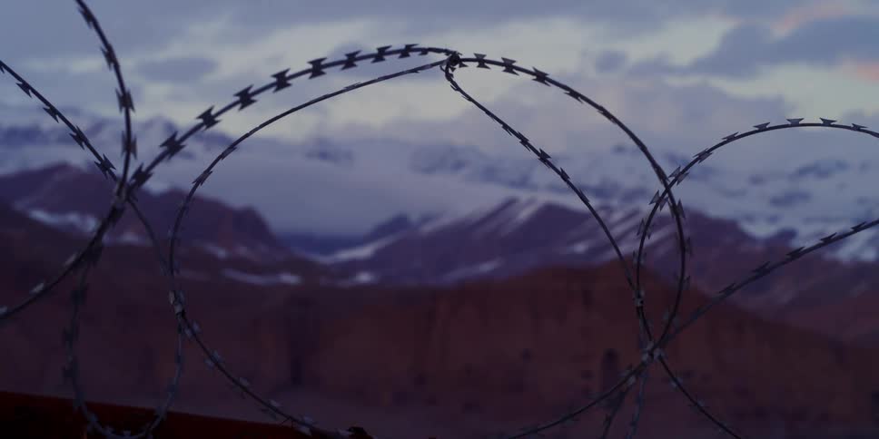 Wire fencing in front of a mountain range