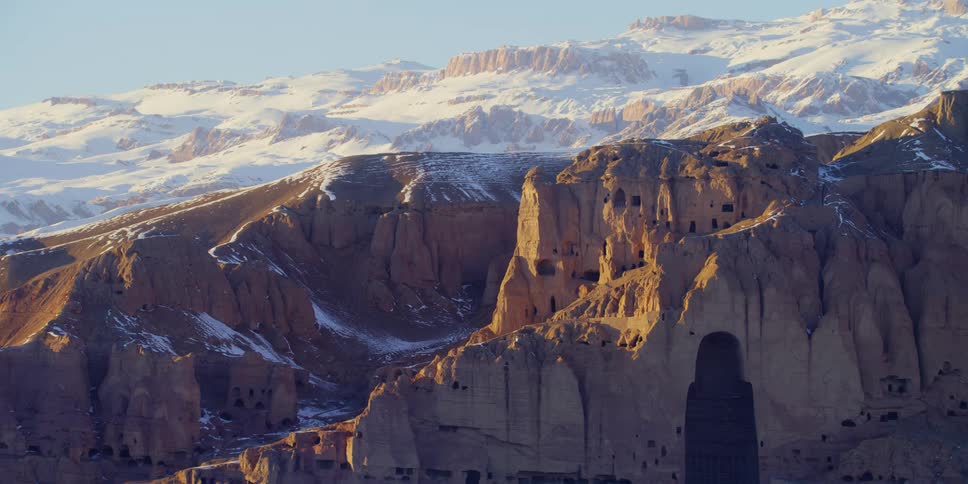 An aerial view of a mountain at dusk is displayed