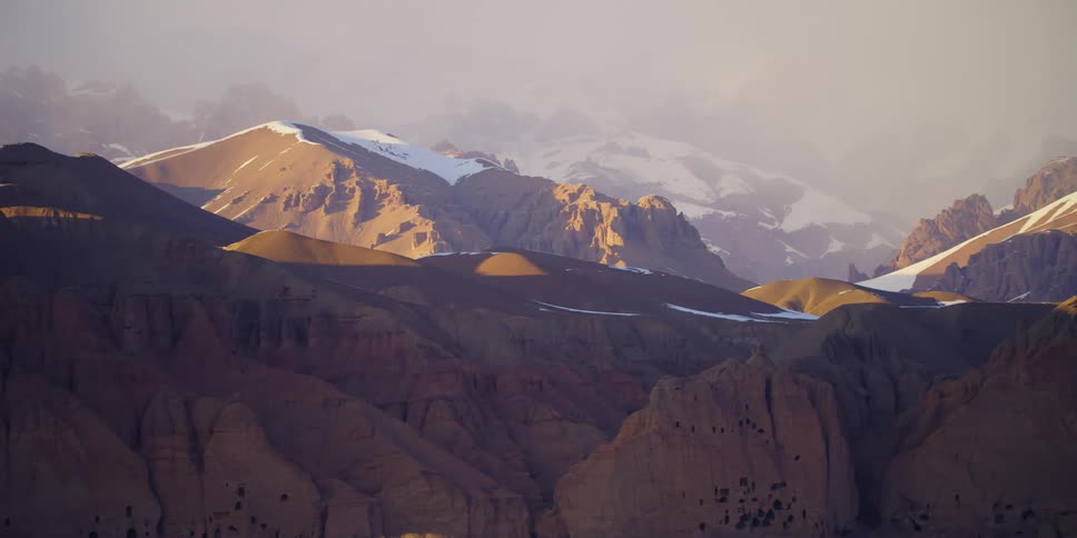 An aerial view of a mountain range is displayed