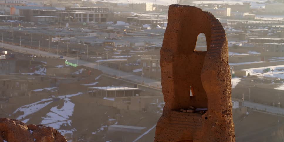 A large rock formation sits in front of a skyline