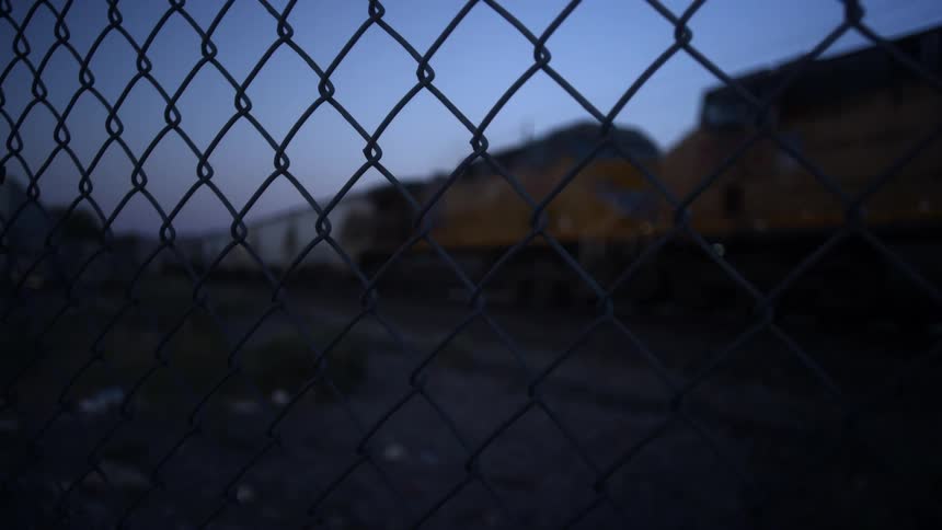 A cargo train traveling down the tracks