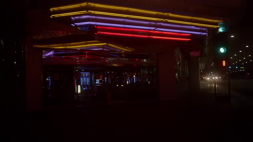 Colorful neon sign over the entrance of a casino in a city at night
