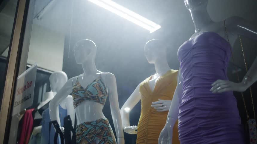 The shop window is full of mannequins in dresses