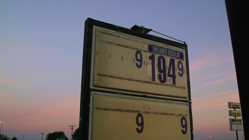 A sign displaying fuel prices at a gas station
